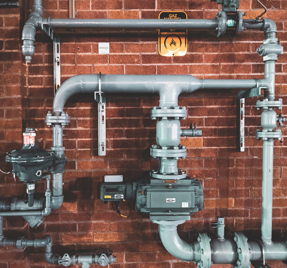 hot water cylinder plumbing inside a commercial building
