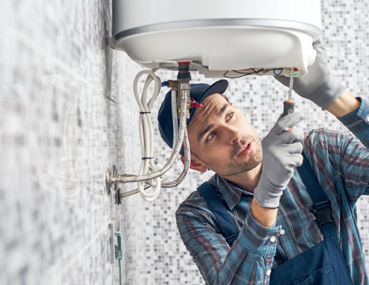 plumber servicing hot water cylinder